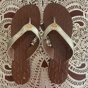 Tory Burch leather flip flops with gold straps. Size 7M.